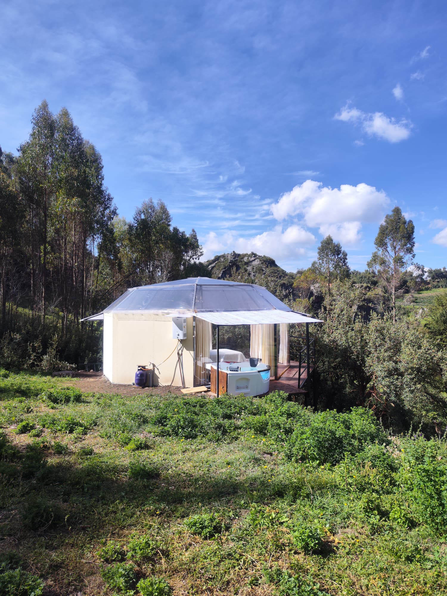 Glamping de lujo en domo con cama e iluminación en la naturaleza